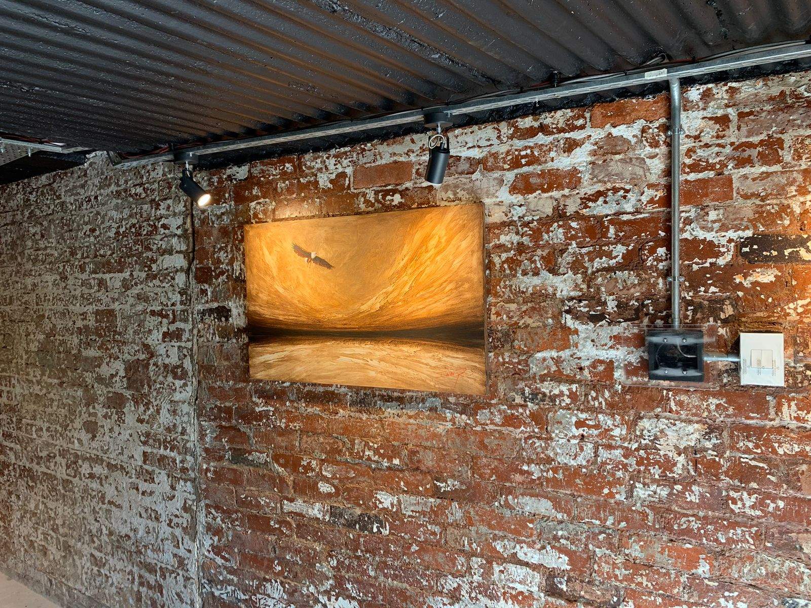 Hidden Amina speaker integrated into artwork in the entertainment room