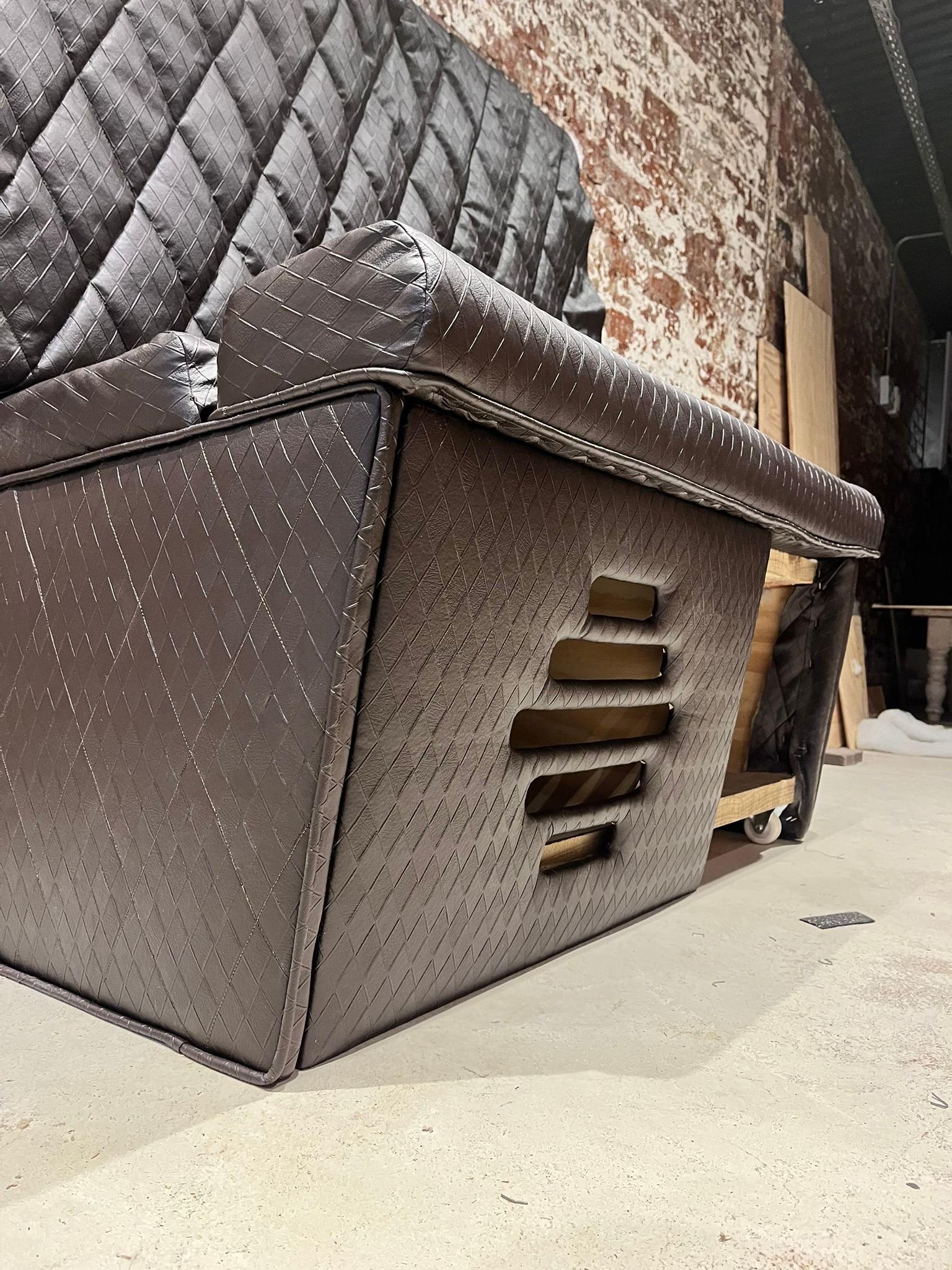 Custom couch with integrated subwoofer vent in the entertainment room