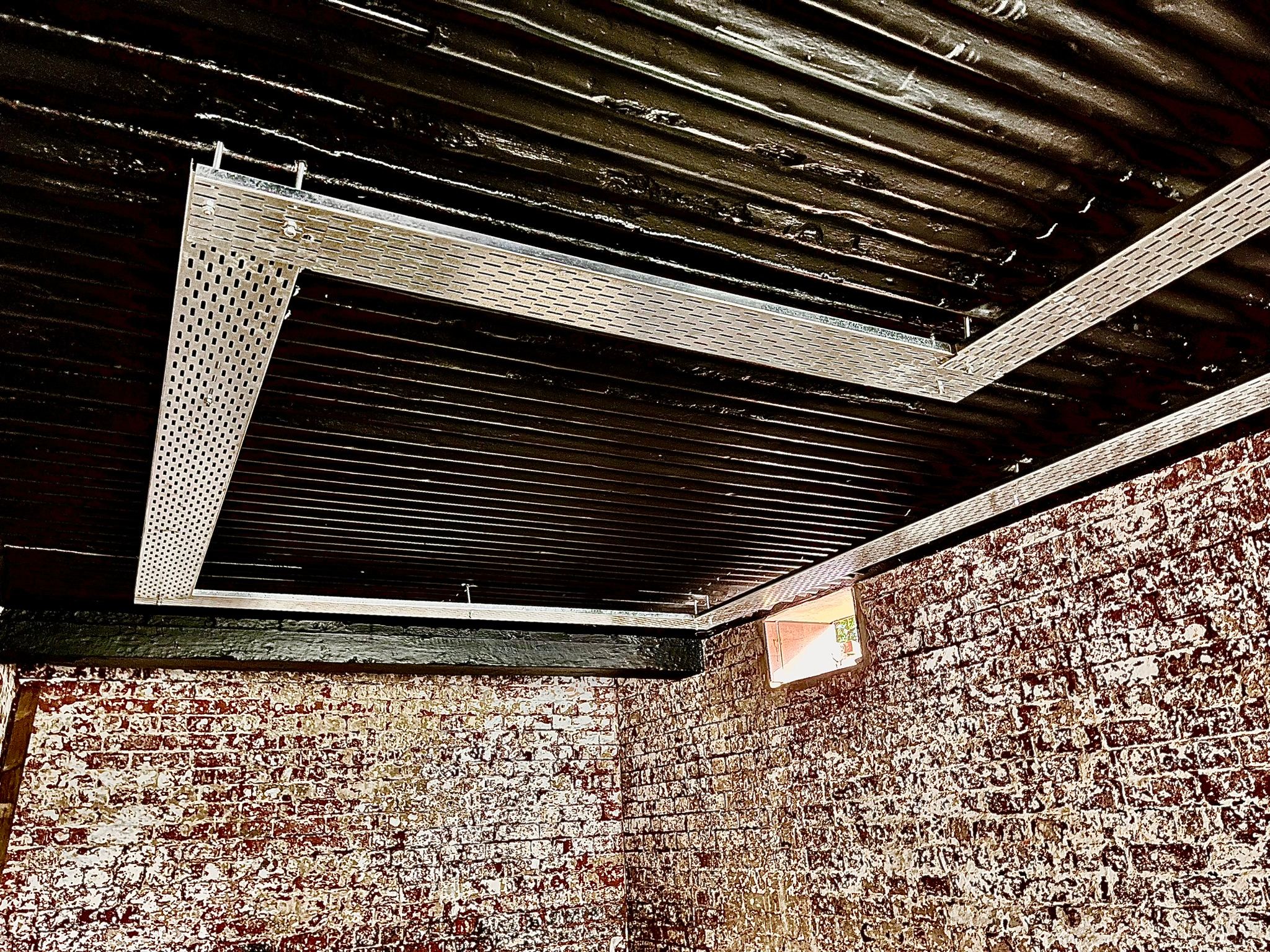 Surface-mounted cable tray integrated into the ceiling design