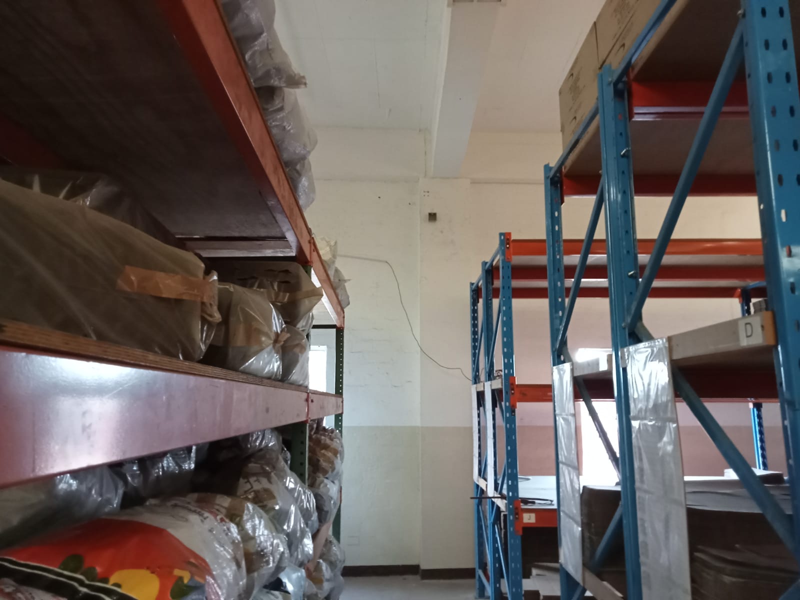 Commercial CCTV camera view down a warehouse aisle