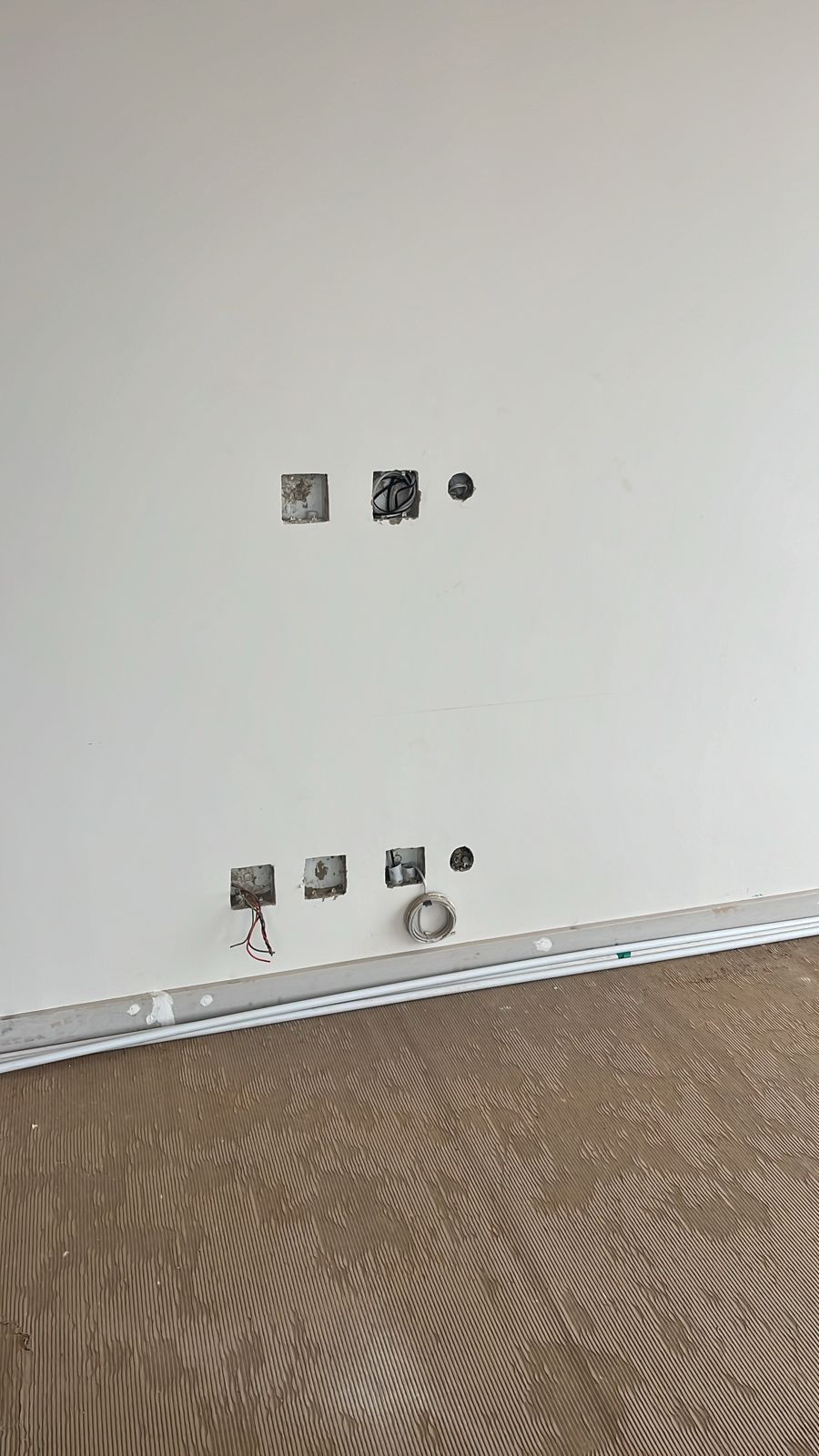 Low-voltage wiring in place before cabinetry and wall finishes are completed